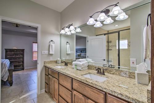 a bathroom with two sinks and a large mirror at South Padre Paradise with Saltwater Pool Near Golf! in Laguna Vista