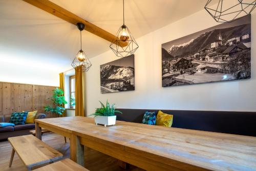 a dining room with a wooden table and chairs at Chalet SONNECK Summer Card included in Kaprun
