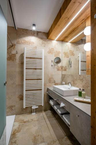 a bathroom with a sink and a mirror at Landhaus Tanner in Waging am See