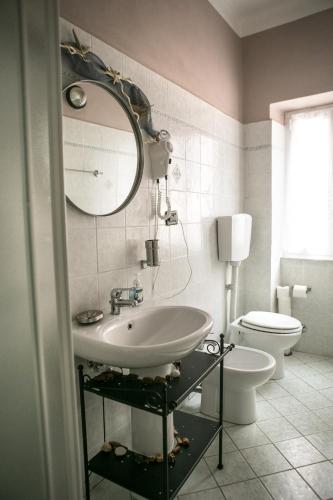 a bathroom with a sink and a toilet and a mirror at Vernazza2010 Rooms in Vernazza