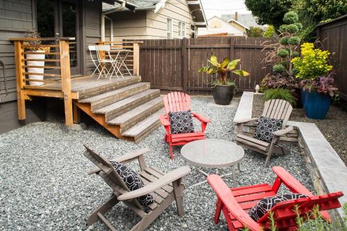 a patio with chairs and a table and a staircase at Updated Tacoma Home with Patio 3 Mi to Downtown in Tacoma