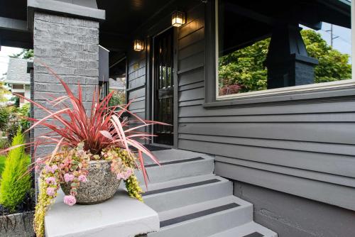 a potted plant sitting on the steps of a house at Updated Tacoma Home with Patio 3 Mi to Downtown in Tacoma