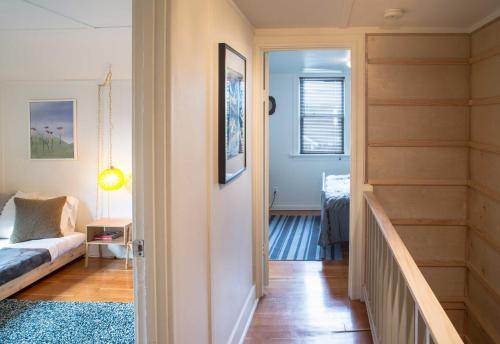 a hallway with a stairway leading to a living room at Updated Tacoma Home with Patio 3 Mi to Downtown in Tacoma