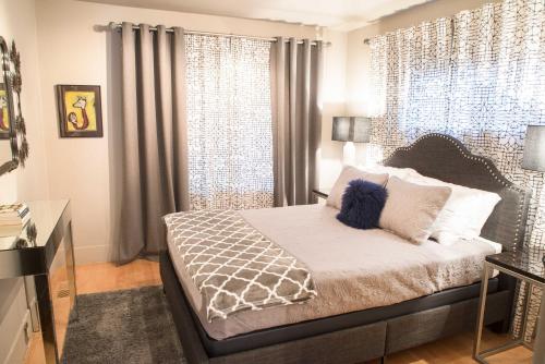 a bedroom with a bed with a large window at Updated Tacoma Home with Patio 3 Mi to Downtown in Tacoma
