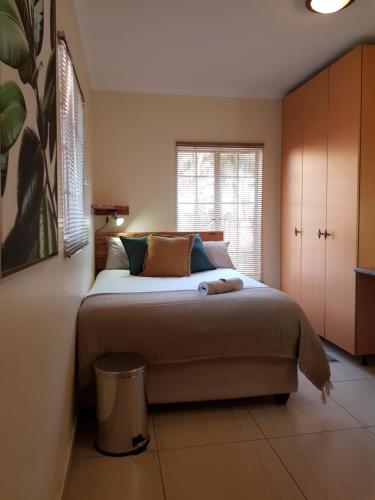 a bedroom with a large bed and a window at Kington Guest Suite in Pretoria