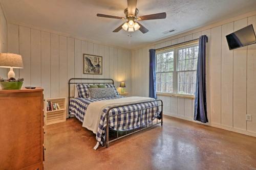 a bedroom with a bed and a ceiling fan at Peaceful Family Cabin on 10 Acres with Game Room! in Heflin