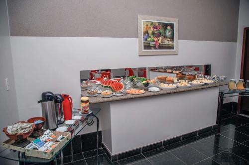 a buffet of food on a counter in a room at Hotel Astoria in Palmas