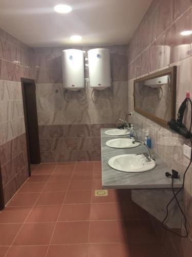 a bathroom with two sinks and a mirror at Petra Cabin Inn Hostel&Resturant in Wadi Musa