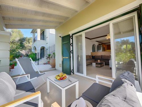 a living room with a couch and a table at Spacious 4-Bedroom Villa with Private Pool and Stunning Sunset Views, 3 Minutes from the Beach in Afionas