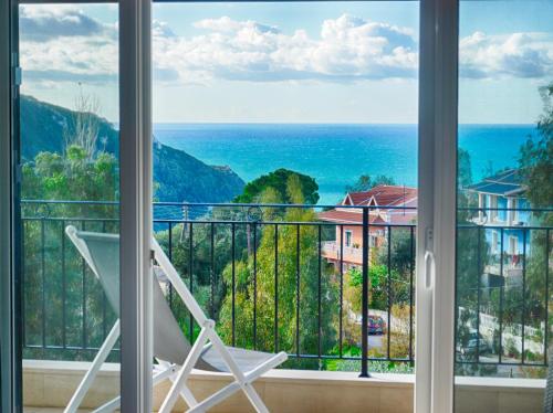 a room with a view of the ocean from a window at Spacious 4-Bedroom Villa with Private Pool and Stunning Sunset Views, 3 Minutes from the Beach in Afionas