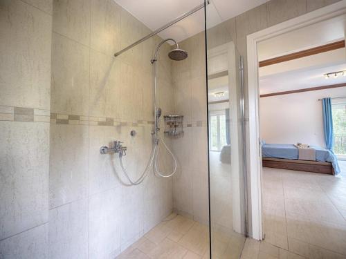 a shower with a glass door in a bathroom at Spacious 4-Bedroom Villa with Private Pool and Stunning Sunset Views, 3 Minutes from the Beach in Afionas