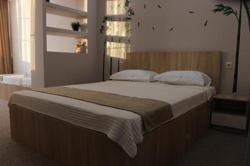a bedroom with a large bed with white sheets and pillows at Riva in K'obulet'i