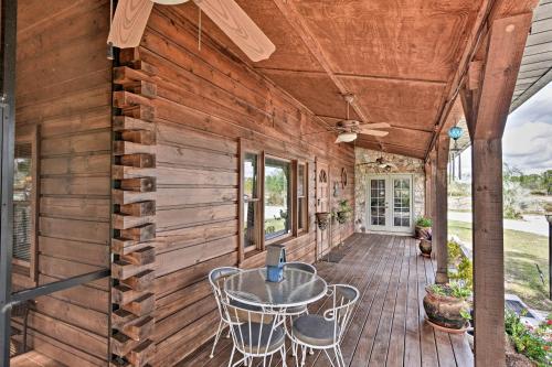 a wooden deck with a table and chairs on it at 40-Acre Farm with Animals and Fishing in Sebring! in Sebring