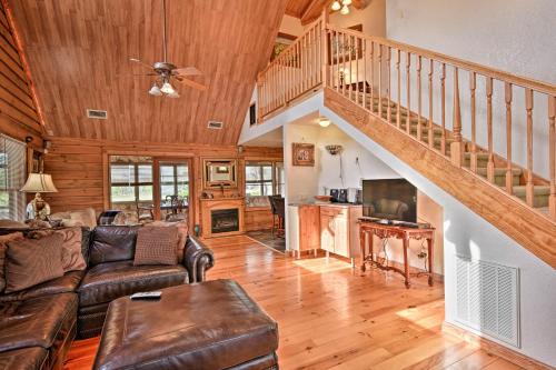 a living room with a couch and a staircase at 40-Acre Farm with Animals and Fishing in Sebring! in Sebring