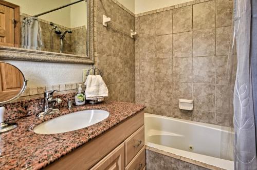 a bathroom with a sink and a tub at 40-Acre Farm with Animals and Fishing in Sebring! in Sebring