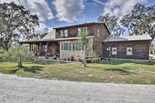 a large wooden house with a yard at 40-Acre Farm with Animals and Fishing in Sebring! in Sebring