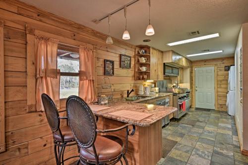 a kitchen with wooden walls and a table and chairs at 40-Acre Farm with Animals and Fishing in Sebring! in Sebring
