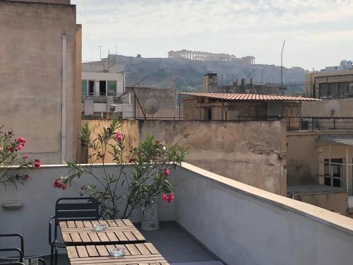 a balcony with tables and chairs on a building at Boutique Central Apartments Acropolis View in Athens