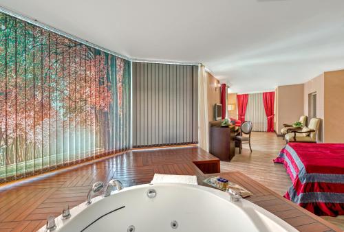 a bath room with a tub and a window at Sealife Family Resort Hotel in Antalya