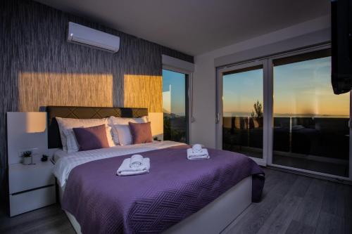 a bedroom with a bed with two towels on it at Villas Alfa & Omega in Klis