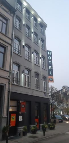 a building with a sign on the side of it at Urban City Centre Hostel in Brussels