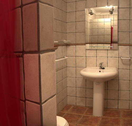 a bathroom with a sink and a toilet at Casa da Praça in Torre de Moncorvo