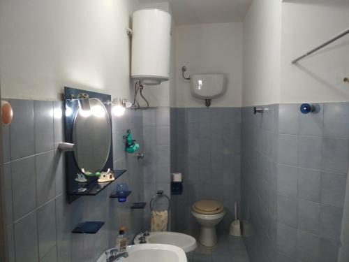 uma casa de banho com um WC, um lavatório e um espelho. em La dolce vita, relax & kite Lamezia em Lamezia Terme