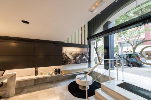 a living room with a bench and a large window at Atenea Rekord Suites in Barcelona