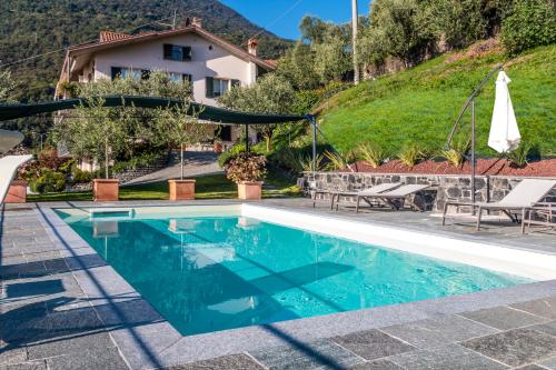 a villa with a swimming pool and a house at IseoLakeRental - Vacanza Romantica in Riva di Solto
