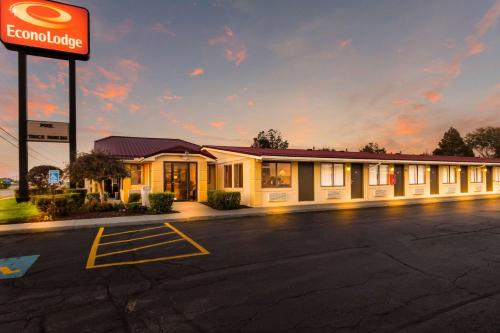 a fast food building with a sign in a parking lot at Econo Lodge in Norwalk