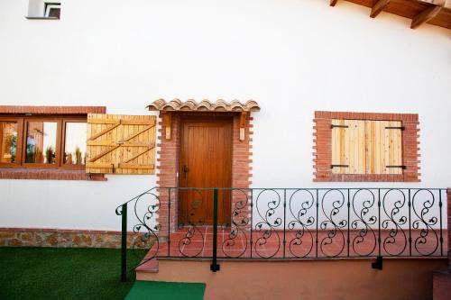 a house with a balcony with a wooden door at Can Prats in Ríudecañas