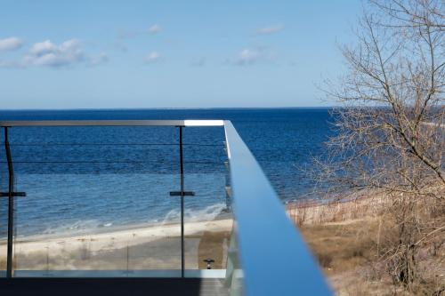 a view of the ocean from the balcony of a house at Hotel Skipper in Rewa