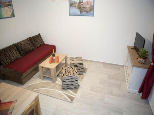 a living room with a couch and a table at Apartments Phoenix in Ivanica