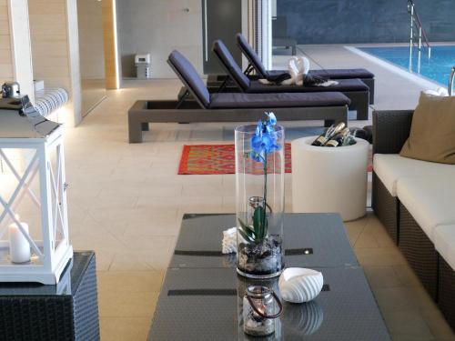 a living room with a glass vase on a table at Hotel Skipper in Rewa