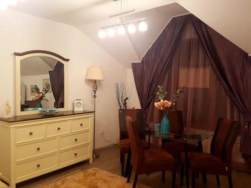 a dining room with a glass table and a dresser at Apartament Fluturaș de Stâncă Comarnic in Comarnic