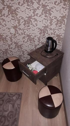 a table with a tea kettle on it next to a wall at MANGO Guesthouse in Sighnaghi