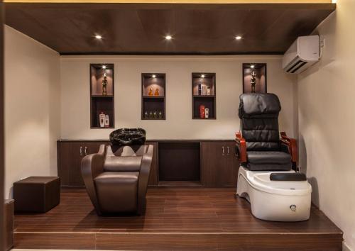 a barbershop with a chair and a pile of furniture at Lemon Tree Premier, Rishikesh in Rishīkesh