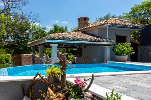 a villa with a swimming pool and a house at Apartment Roko in Županje