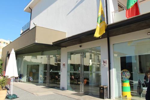 a store front with glass windows and a flag at Hotel Minho Belo in Vila Nova de Cerveira