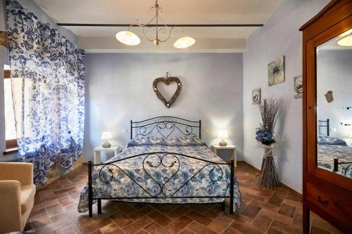 a bedroom with a bed with blue and white curtains at Agriturismo MonteCrespini in Saturnia