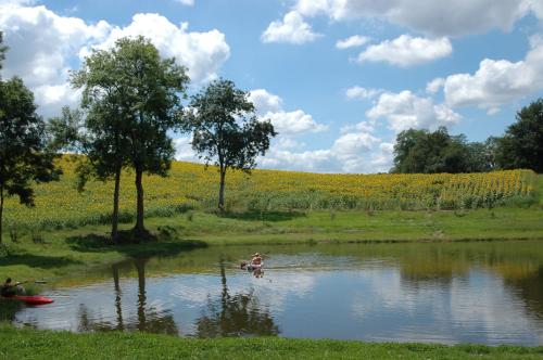 a man is in the water in a river at Villa Gites Chambre d hôtes avec piscine Dordogne 2-4-6-8-10 personnes in Bussière-Badil