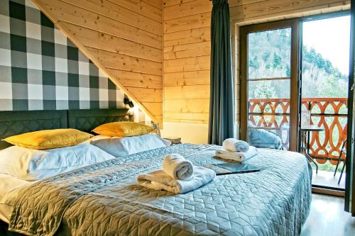 sypialnia z łóżkiem z ręcznikami w obiekcie Apartamenty Magia Gór w mieście Szczawnica