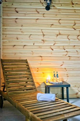 a room with a wooden wall with a table and a bench at Apartamenty Magia Gór in Szczawnica