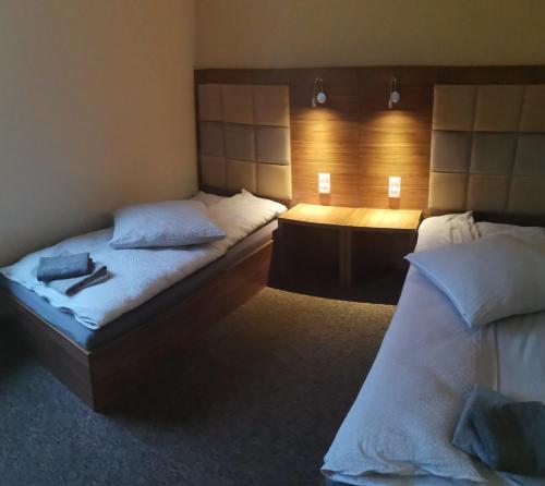 a hotel room with two beds and a desk at Hotel Holidays in Słubice