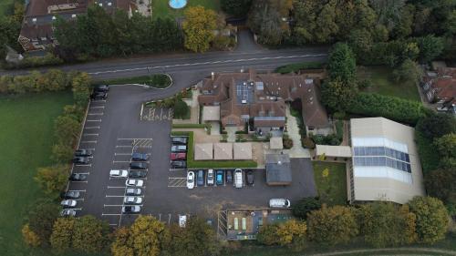 arial view of a house with a parking lot at Hurley House Hotel in Hurley