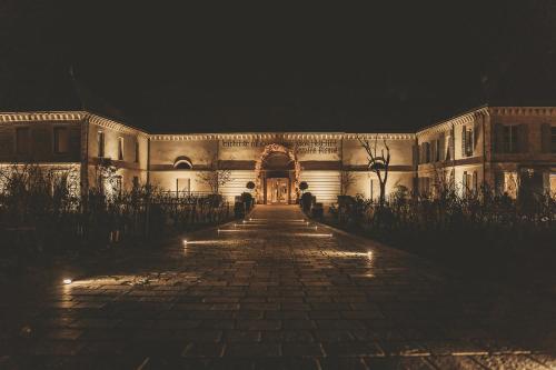 a building at night with a cobblestone street at Chateau de Chassagne-Montrachet in Chassagne-Montrachet