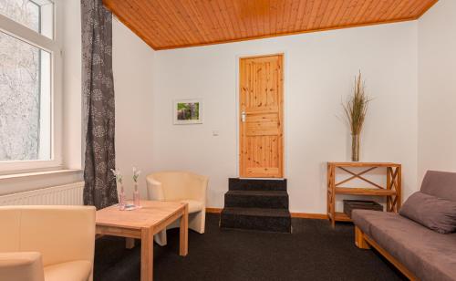 a living room with a couch and a table at Hotel Rutherbach in Essen