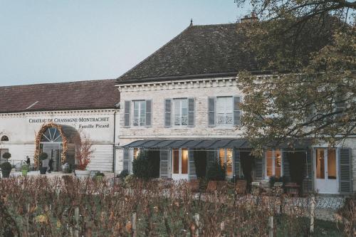 a white house with a black roof at Chateau de Chassagne-Montrachet in Chassagne-Montrachet