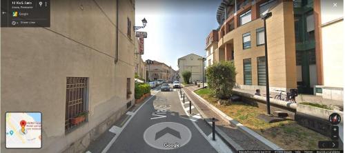 a rendering of a street in a city with buildings at Hotel Spagna in Arona