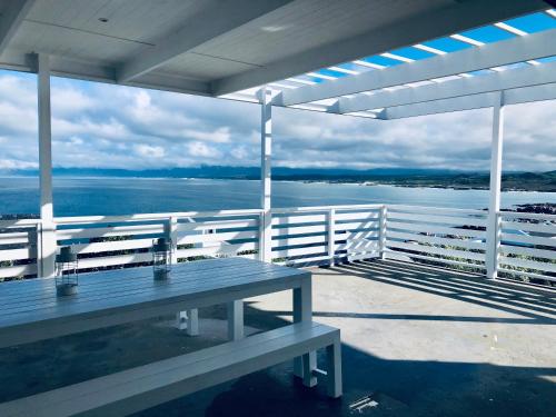 a picnic table on a deck with a view of the water at Seascape in De Kelders
